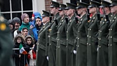 Members of the public wait for the President of Ireland Michael D. Higgins to inspect the Irish defense forces guard of honour at Dublin Castle, Ireland, Friday Jan. 1, 2016.
