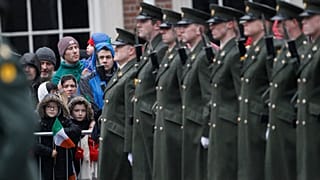 Members of the public wait for the President of Ireland Michael D. Higgins to inspect the Irish defense forces guard of honour at Dublin Castle, Ireland, Friday Jan. 1, 2016.