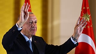 Recep Tayyip Erdogan gestures to supporters at the presidential palace, in Ankara.