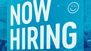 A hiring sign is displayed at a fast food restaurant in Northbrook, IL, May 2023