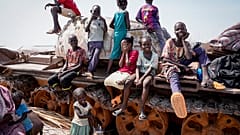 Children sit and play on the remains of a tank, at the river port in Renk, South Sudan Wednesday, May 17, 2023.