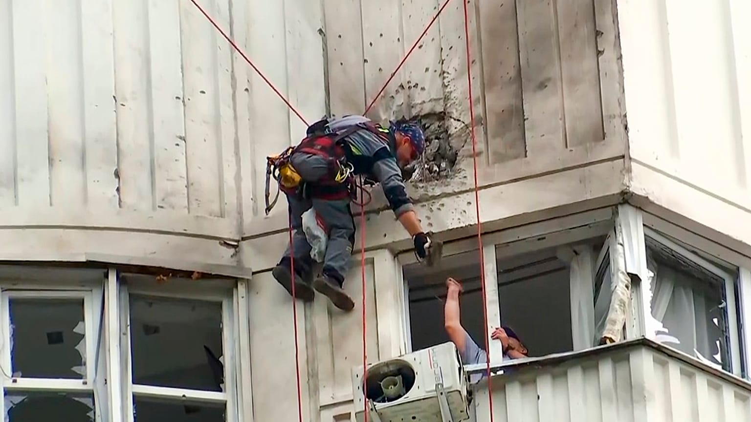 Investigators inspect the building after a Ukrainian drone damaged an apartment building in Moscow, Russia, Tuesday, May 30, 2023.