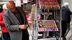 A man reads Turkish newspapers a day after the presidential election day in Istanbul, Turkey, Monday, May 29, 2023. 