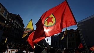 Pro Kurdish activist wave a Kurdistan Workers Party, PKK, flag and shout slogans as they protest against Turkish military operations on 9 October 2019.