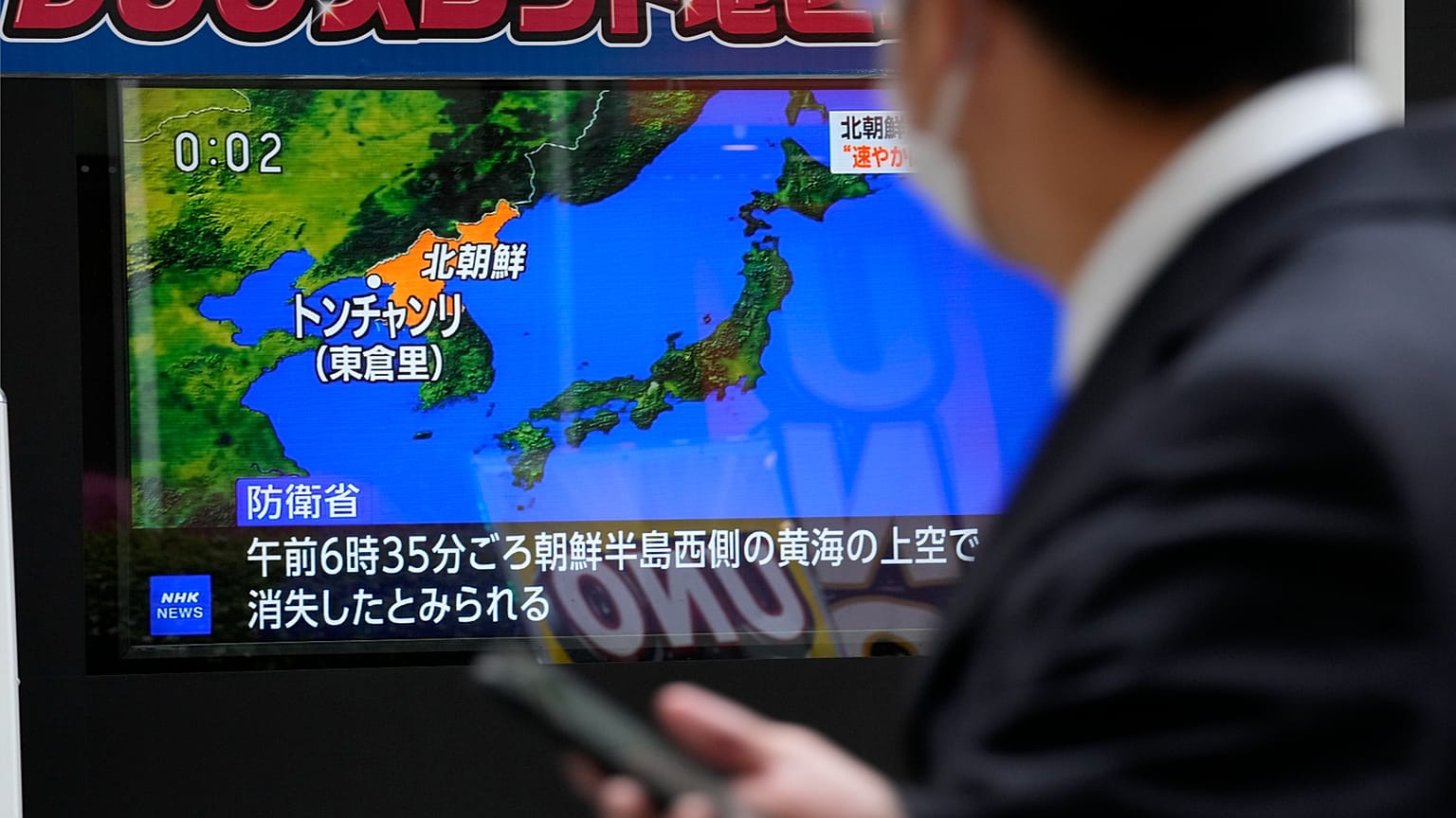A public TV screen broadcasts news of North Korea's launch of its first spy satellite