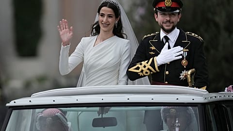 The Crown Prince and Princess of Jordan parade through the streets of Amman after marrying at Zahran palace