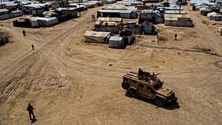 Kurdish forces patrol al-Hol camp, which houses families of members of the Islamic State group in Hasakeh province, Syria.