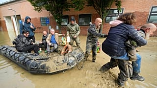 The floodwaters were so high, firefighter and coastguard helicopters were needed to rescue some residents who climbed onto rooftops of three-story buildings to avoid drowning.