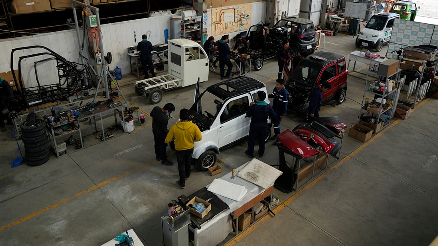 Employees work on a Quantum electric car assembly line at a factory in Cochabamba, Bolivia.