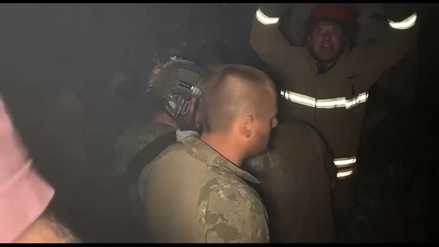 Rescuers try to reach victims trapped under rubble after a Russian airstrike on a residential district of Dnipro. June 3, 2023