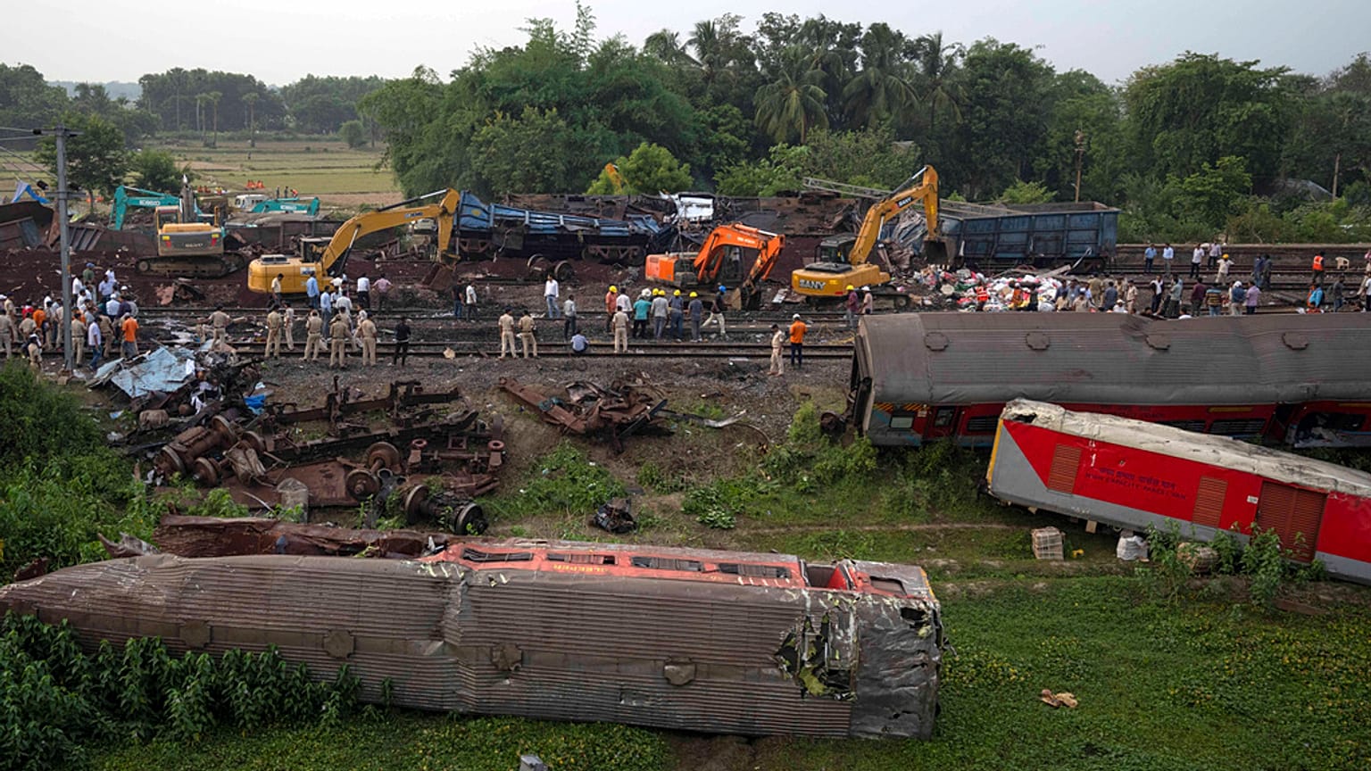 People watch at the site where trains that derailed, in Balasore district, in the eastern Indian state of Orissa, Sunday, June 4, 2023.