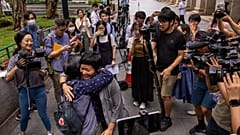 Award-winning Hong Kong journalist Bao Choy, front right, hugs Sham Yee-lan, former Hong Kong Journalists Association chairperson, after being cleared by the city's top court 