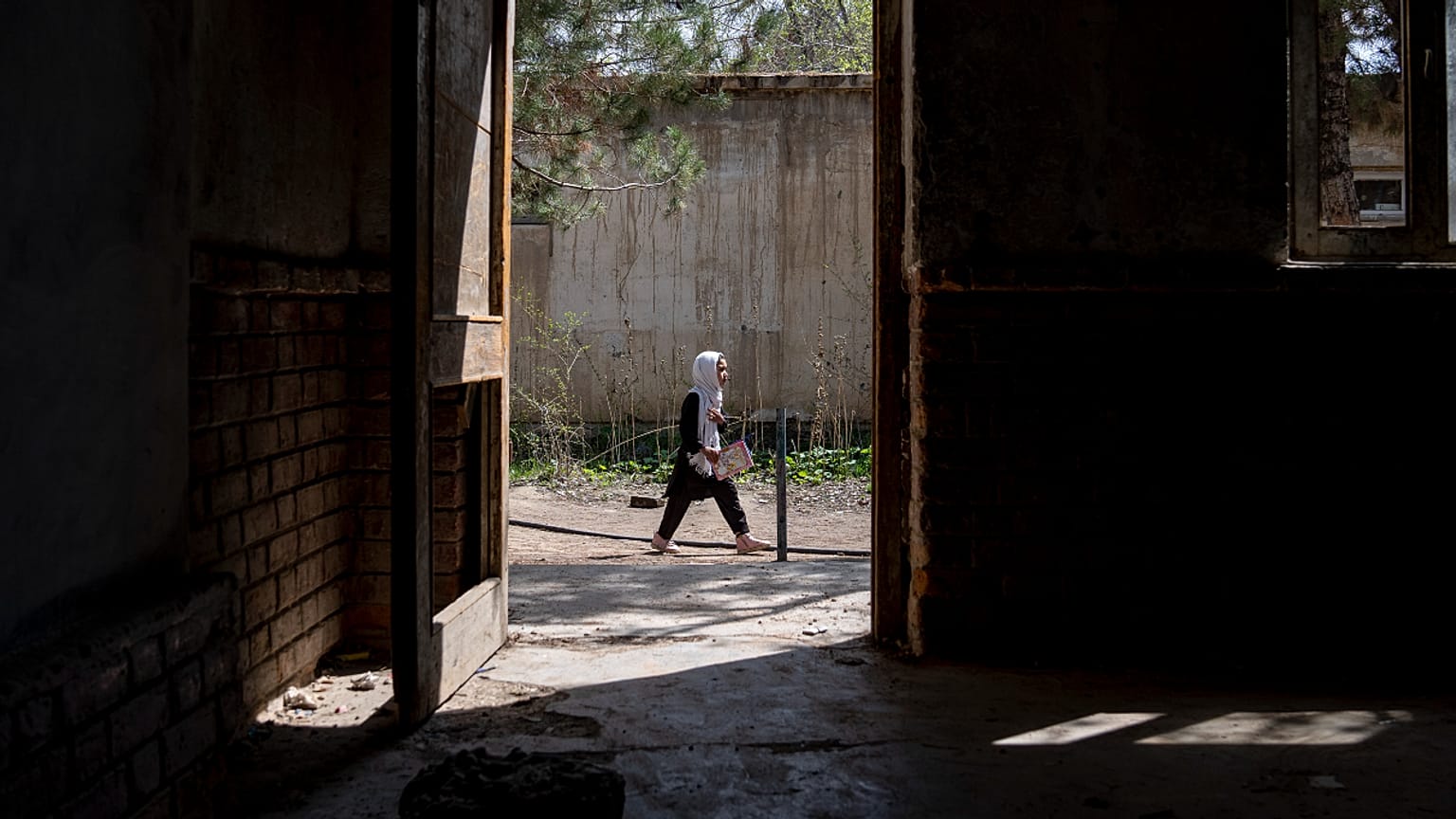 A girl walks to school on the first day of the school year, in Kabul, Afghanistan. 