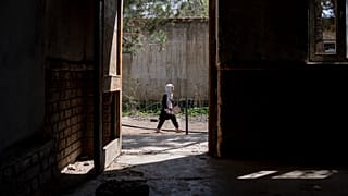 A girl walks to school on the first day of the school year, in Kabul, Afghanistan. 
