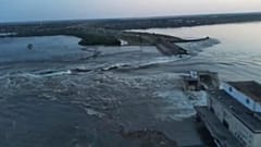 Image released by the Ukrainian Presidential Office, water runs through a breakthrough in the Kakhovka dam in Kakhovka, Ukraine, Tuesday, June 6, 2023
