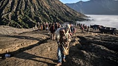 Members of the Tengger sub-ethnic group carries a goat for offering on the active Mount Bromo volcano as part of the Yadnya Kasada festival in Probolinggo, East Java.