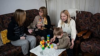 FILE - Ukrainian refugees sit in a home of a resident in the village of Guissona, Lleida, Spain, Thursday, March 17, 2022. 