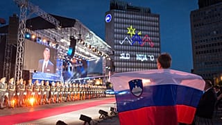 A boy holds a Slovenian flag during the ceremony to celebrate the 30th Anniversary of Slovenian independence in Ljubljana.