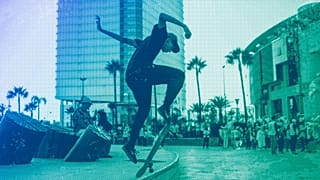 A youth skateboards as campaigners hold a rally for the upcoming legislative and regional elections in Rabat, September 2021