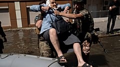 A woman is evacuated from a flooded neighborhood in Kherson, Ukraine, Wednesday, June 7, 2023 after the walls of the Kakhovka dam collapsed.