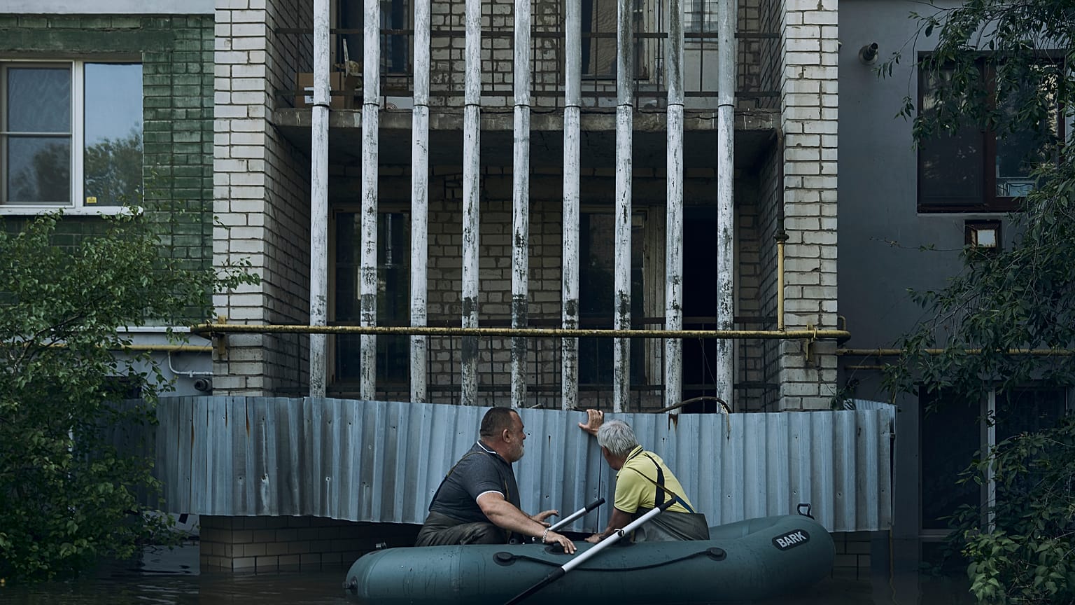 Residents in a small boat in the flooded region.