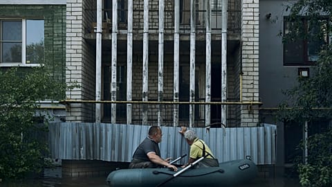Residents in a small boat in the flooded region.