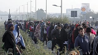 مهاجرون يصطفون للتسجيل في مخيم مؤقت للمهاجرين يُعرف باسم "الغابة" بالقرب من كاليه، شمال فرنسا 