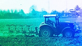 A farmer plows a field with his tractor in Cisliano, March 2022