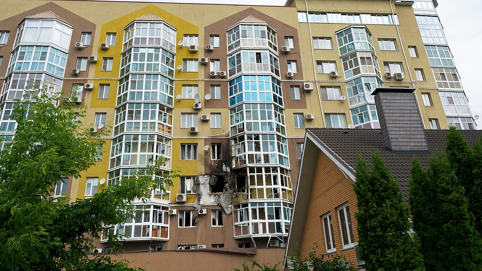 Broken windows and traces of fire are seen after a drone fell at a residential building in Voronezh, Russia, Friday, June 9, 2023. 