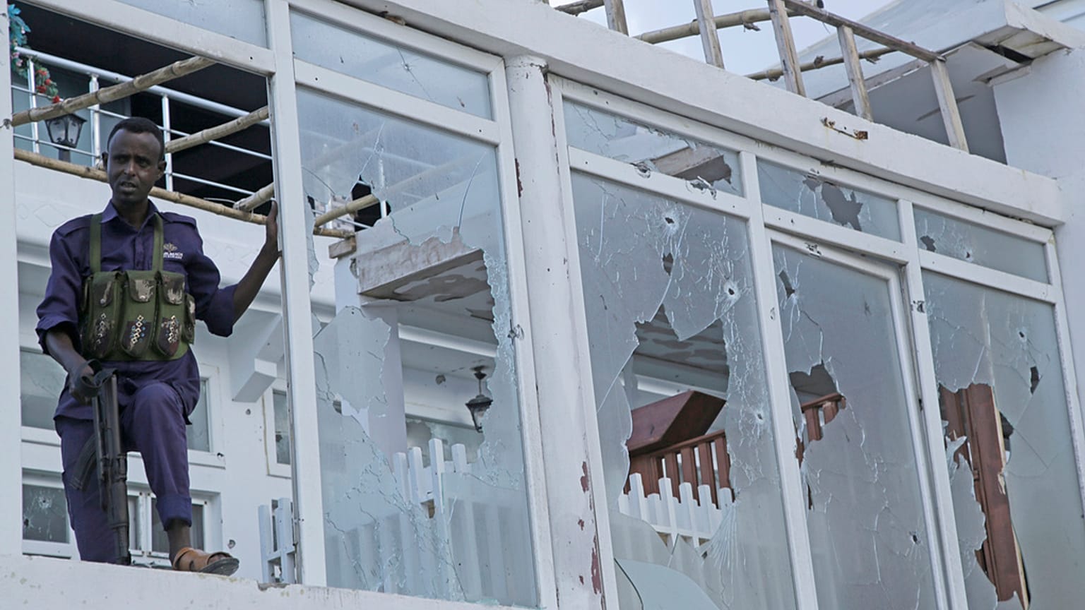 A Somali soldier stands guard with destroyed window of the Pearl Beach hotel in Mogadishu, Somalia, Saturday, June 10, 2023. 