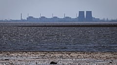 The Zaporizhzhia nuclear power plant is seen in the background of the shallow Kakhovka Reservoir.