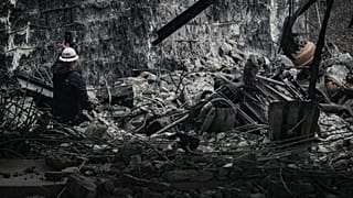 An investigator surveys the aftermath of an elevated section of Interstate 95 that collapsed, in Philadelphia, Monday, June 12, 2023.