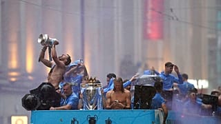 Manchester City's Ruben Dias and Erling Haaland celebrate during the parade to celebrate winning the Premier League, FA Cup and Champions League in Manchester, 12 June 2023