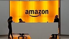 FILE - In this 14 February 2019 photo, people stand in the lobby for Amazon offices in New York.
