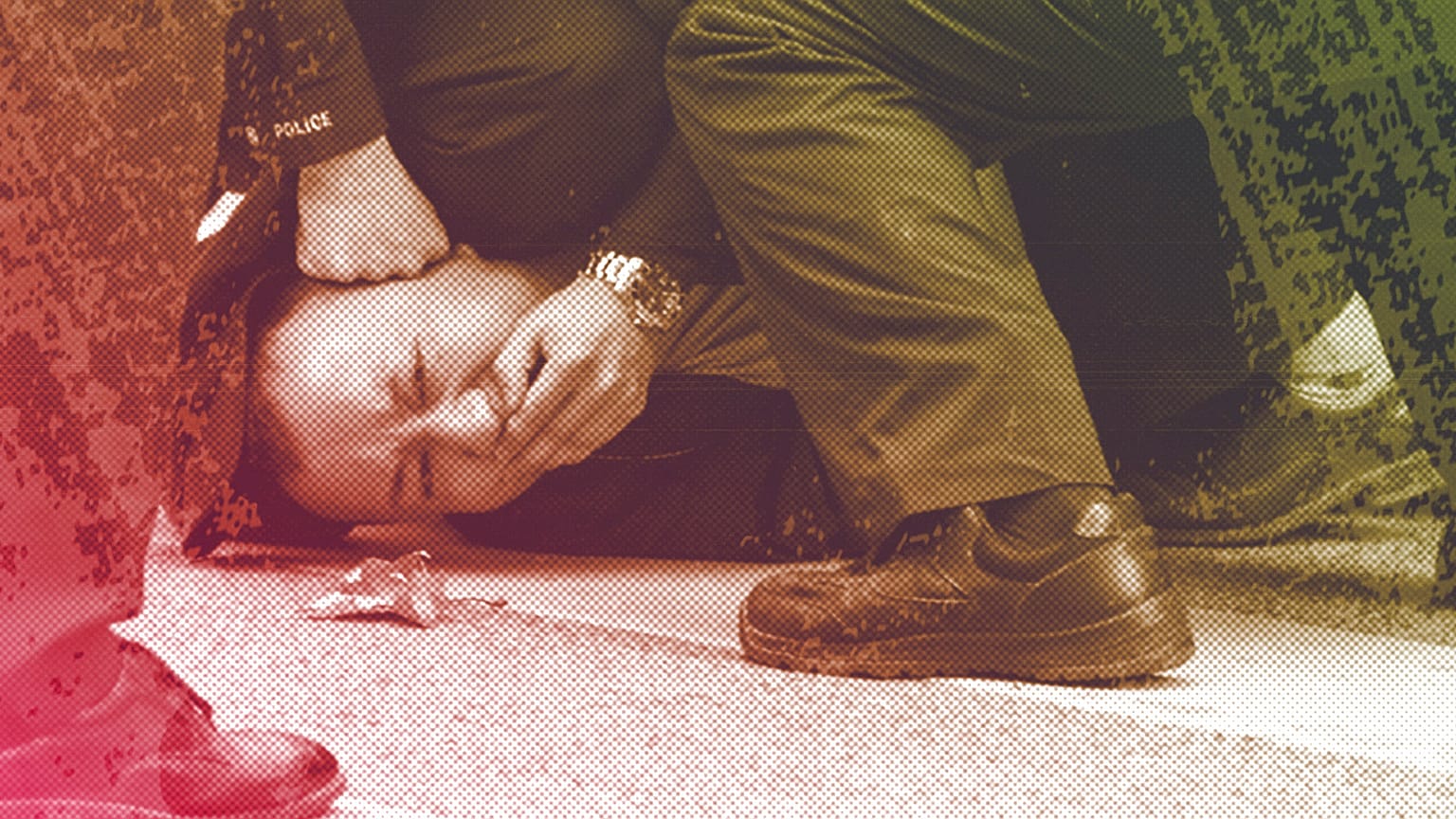 Chinese policemen pin down and detain a protester during a protest against anti-virus measures on a street in Shanghai, November 2022