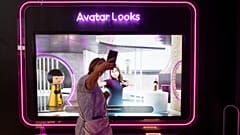 A visitor plays with her avatar at the Loreal group booth during the Vivatech technology startups and innovation fair at the Porte de Versailles exhibition centre in Paris.