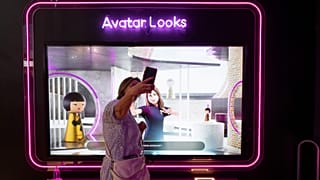 A visitor plays with her avatar at the Loreal group booth during the Vivatech technology startups and innovation fair at the Porte de Versailles exhibition centre in Paris.