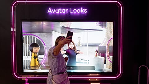 A visitor plays with her avatar at the Loreal group booth during the Vivatech technology startups and innovation fair at the Porte de Versailles exhibition centre in Paris.