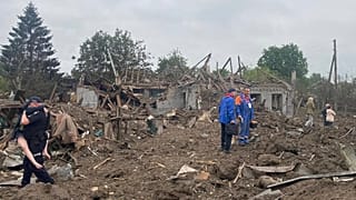 A Ukrainian police officer carries a wounded victim of the deadly morning Russian rocket attack amid debris of the ruined private houses in Kramatorsk,Ukraine, 14 June 2023