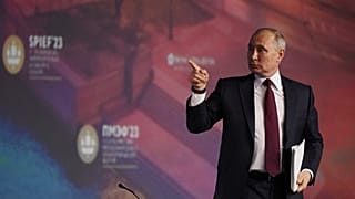 Vladimir Putin leaves a plenary session of the St. Petersburg International Economic Forum.