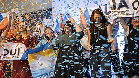 Supporters of the climate change bill throw confetti, in Bern, Switzerland, Sunday, June 18, 2023.