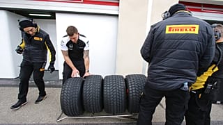 Pirelli technicians check tires during a testing session of Pirelli Formula One.