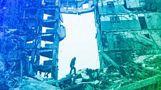 A resident looks for belongings in a destroyed apartment building in Borodyanka, April 2022