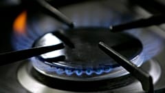 File: A gas-lit flame burns on a natural gas stove.