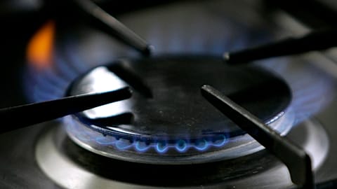 File: A gas-lit flame burns on a natural gas stove.