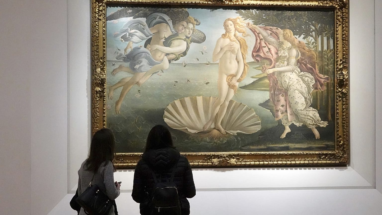 Two visitors admire 15th century painter Sandro Botticelli's Birth of Venus inside the Uffizi Gallery museum in Florence, Italy, Jan. 21, 2021.