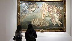 Two visitors admire 15th century painter Sandro Botticelli's Birth of Venus inside the Uffizi Gallery museum in Florence, Italy, Jan. 21, 2021.