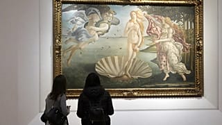 Two visitors admire 15th century painter Sandro Botticelli's Birth of Venus inside the Uffizi Gallery museum in Florence, Italy, Jan. 21, 2021.