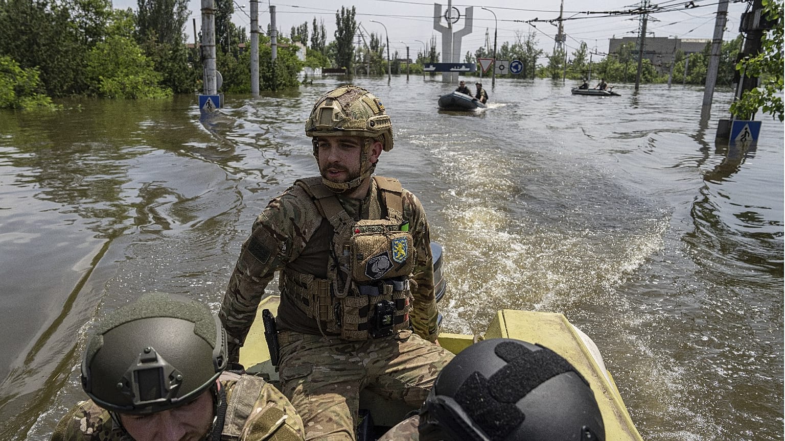 Ukrainian servicemen ride on a speedboat in a flooded neighborhood in Kherson, Ukraine, June 8, 2023.