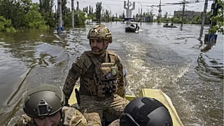 Ukrainian servicemen ride on a speedboat in a flooded neighborhood in Kherson, Ukraine, June 8, 2023.